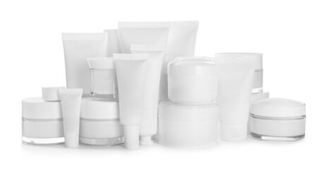 Blank tubes and jars of cosmetic products on white background