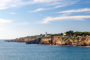 Fototapeta na wymiar Cliffs with fallen rock cliff and formations of Cabo da Guia, next to Cascais and Lighthouse Farol da Guia, Lisbon, Portugal