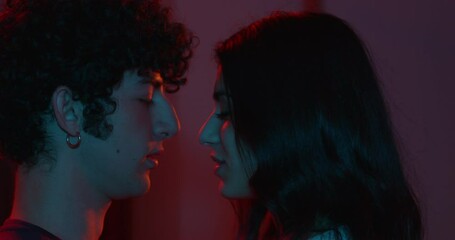 sensuality, erotism - young couple in love kisses passionately in the dark