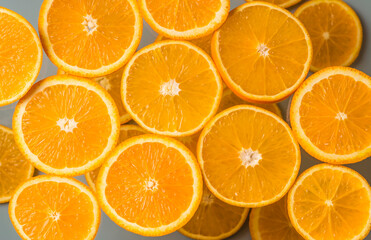 Orange slices on a light background. Juicy citrus fruits. Top view. Healthy natural product.