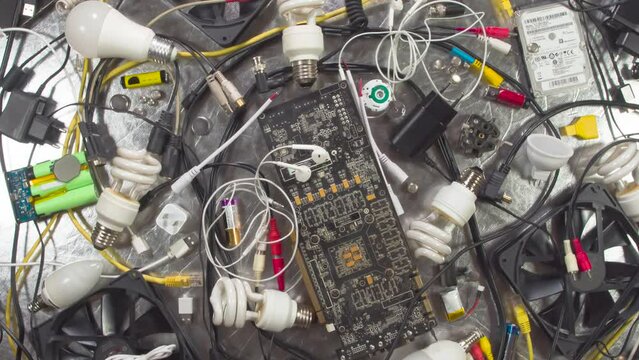 Recycling of Electronic Components. HD Loop. A wide variety of electronic and communications products rotate slowly in front of the camera to symbolize sorting and recycling