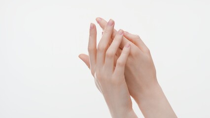Close-up shot of smooth female hands on white background | Hand care commercial concept
