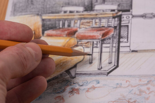The photo shows sketches, a design project drawn with pencils on a piece of paper. Drawings, sketches, pencils, stationery on the table.