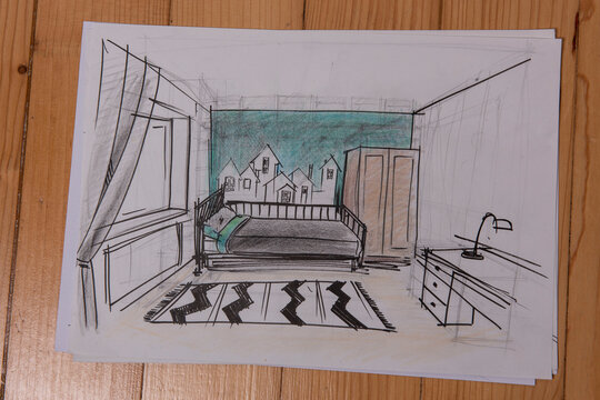 The photo shows sketches, a design project drawn with pencils on a piece of paper. Drawings, sketches, pencils, stationery on the table.