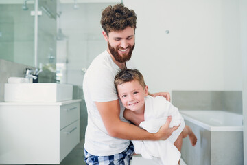 Having a little fun drying off. Cropped shot of a young handsome father drying his adorable little son after a bath in the bathroom at home.