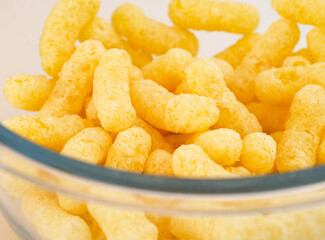 Close-up of Corn puffs in glass bowl - obrazy, fototapety, plakaty