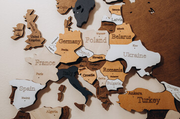Selective focus. Wooden world map on thr wall. Geography concept. Background for travel. Logistics and transportation, worldwide business. Europe close up