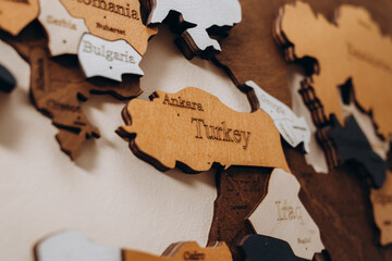 Turkey on a wooden world political map on a wall. - obrazy, fototapety, plakaty