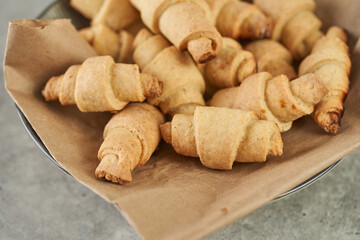 Russian slavic traditional pastry called roguelikes. Cakes bagels. Crispy croissants. Food on grey background, Closeup view