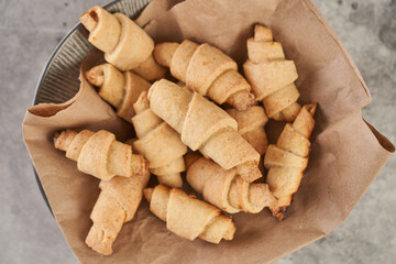 Russian slavic traditional pastry called roguelikes. Cakes bagels. Crispy croissants. Food on grey background, Closeup view