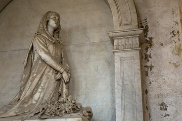 Statue on an old tomb - beginning of 1800, marble - located in Genoa cemetery, Italy