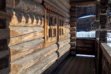 Traditional rural wooden building in north Russia. log walls and windows with carved platbands