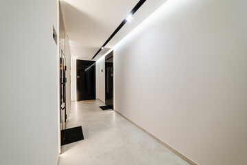 new white corridor with black doors and light