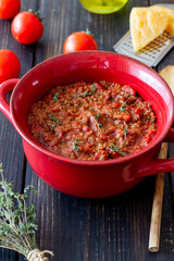 Bolognese sauce on a wooden background. Italian cuisine.