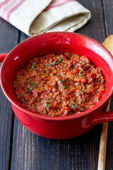 Bolognese sauce on a wooden background. Italian cuisine.