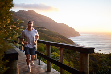 Cardio is good for the soul. Shot of a young man running alone outside.