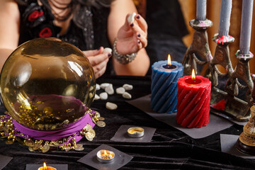 Fortune teller woman without a face in a magic salon works with runes.