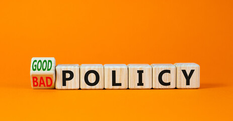 Good or bad policy symbol. Turned wooden cubes and changed concept words Bad policy to Good policy. Beautiful orange table orange background. Business bad or good policy concept. Copy space.