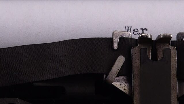 Typing phrase "War in Ukraine" on retro typewriter.