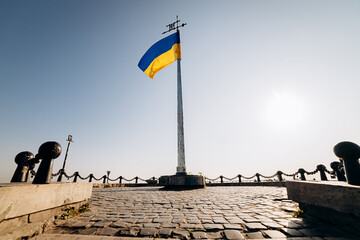 National Yellow-blue Ukrainian flag against the blue sky on mound of Union of Lublin at Castle Hill...