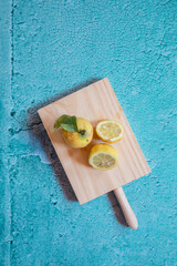 Still Life yellow and lemons in a blue stone background