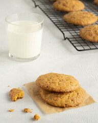 Pumpkin sookies on the cooling rack, glass of milk. Kitchen atmospfere. High key