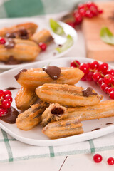 Mini churros with chocolate dipping sauce.