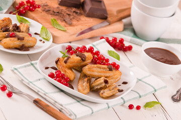 Mini churros with chocolate dipping sauce.