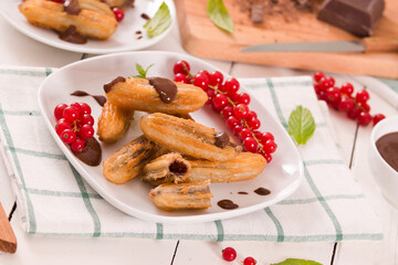 Mini churros with chocolate dipping sauce.