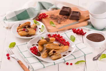 Mini churros with chocolate dipping sauce.