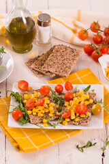 Crispy rye bread with sesame seeds, arugula and sweet corn.