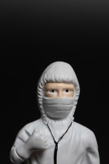 Miniature figurine portrait of an healthcare worker with a surgical mask
