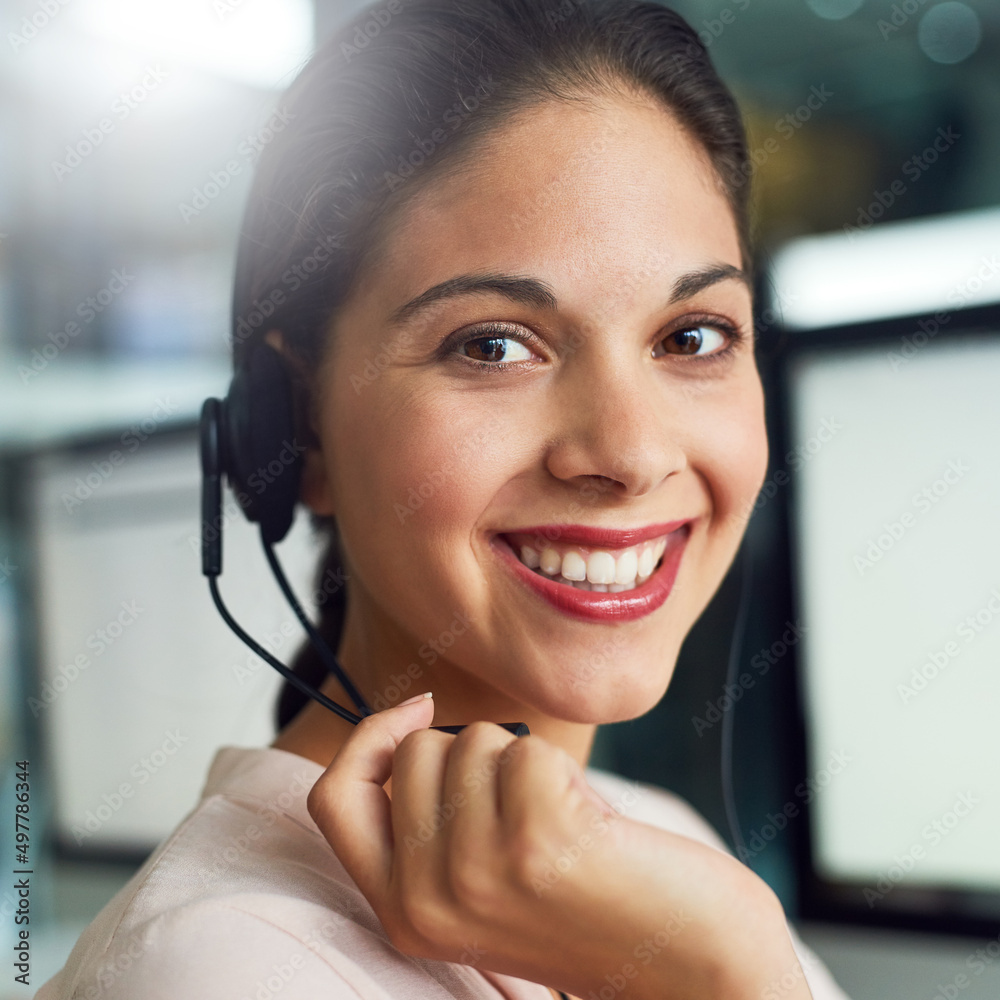 Poster Ready to provide you with the most efficient customer support. Portrait of a young call centre agent working in an office.