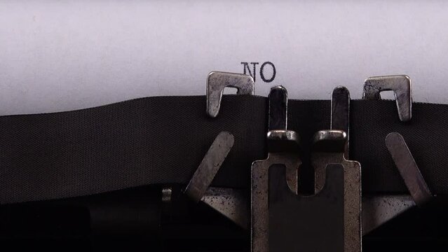 Typing phrase "NO WAR !" on retro typewriter.
