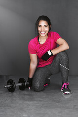 If youre a lifter, you cant be a quitter. Studio shot of an attractive young woman working out with dumbbells against a gray background.