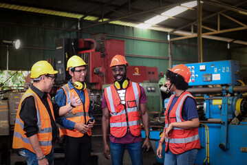 group of diversity teamwork, engineers, technician and workers team in safety uniform are happy morning talk before the start of work in heavy industrial manufacturer factory.