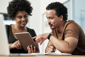 I think you should combine these two ideas. Shot of two young businesspeople sitting together and using a digital tablet in the office.