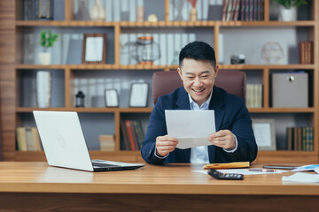 Portrait of a successful businessman, Asian received a letter of approval from the bank, to extend...