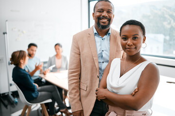 Obraz premium Great teams make great companies. Cropped portrait of two businesspeople attending a meeting in the boardroom with their colleagues in the background.