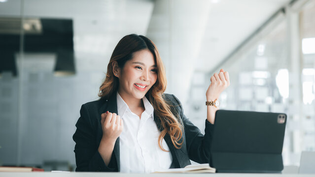 Woman gesturing and looking at tablet screen, businesswoman checking company monthly sales and pretending to be happy as sales meet planned targets according to policy. Sales management concept.