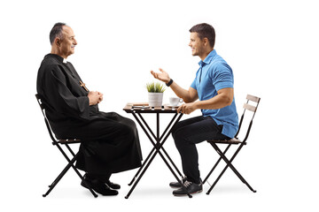 Priest and a young man sitting at a cafe table and talking