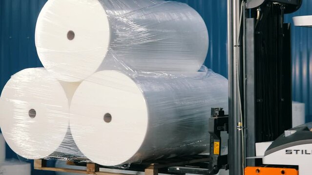 The forklift transports non-woven materials. The forklift transports rolls of agrofibre