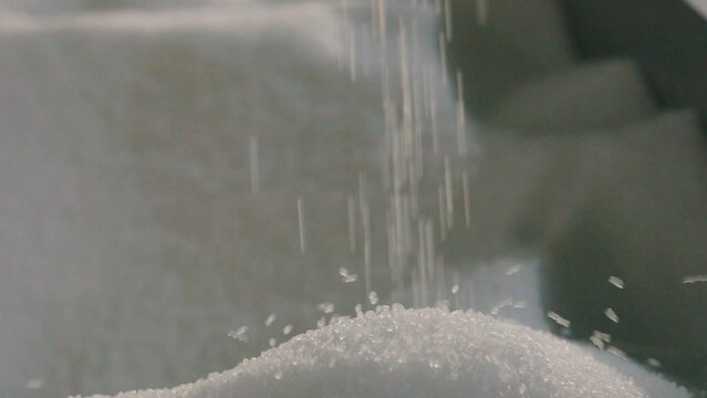 Falling polypropylene granules, slow motion. Polypropylene granules. Polypropylene granules close-up. Nonwoven Fabric Factory