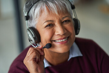 Ready to take your call. Portrait of a mature woman working in a call centre.