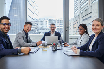 We cant wait to fill the city with our big ambitions. Portrait of a group of businesspeople having a meeting in a boardroom. - obrazy, fototapety, plakaty
