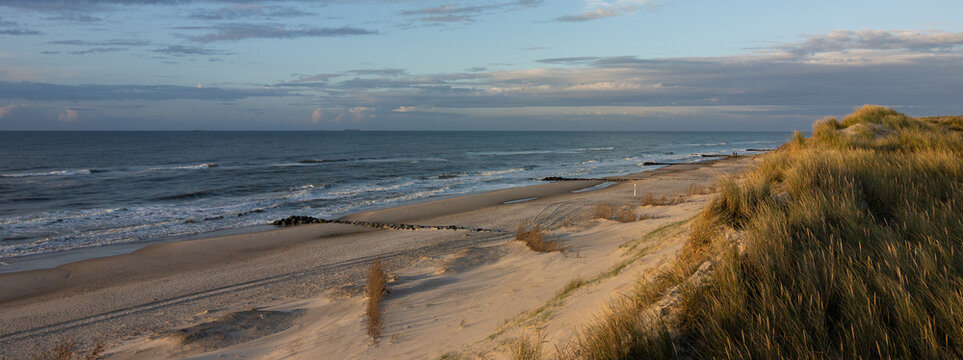Panoramic view to the wide sandy beach with beautiful dune landscape.