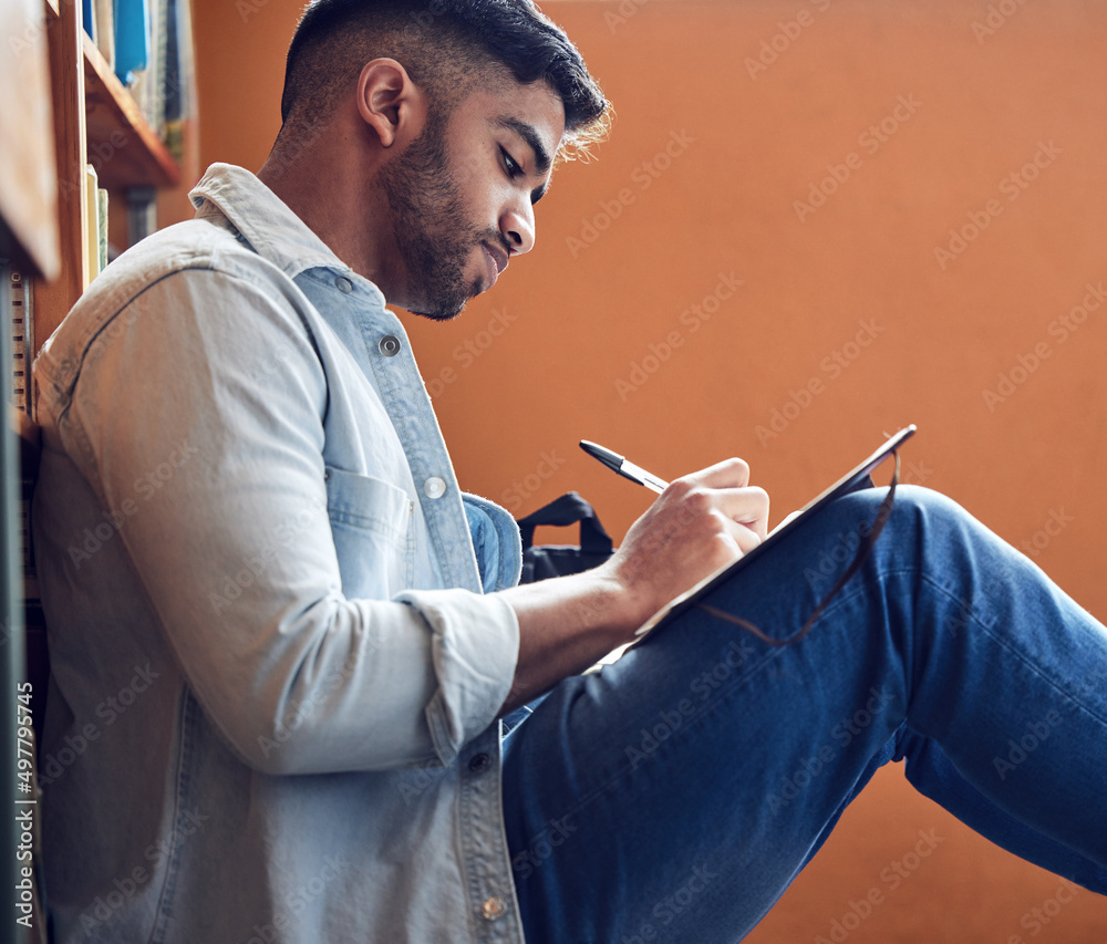 Aufkleber an investment in knowledge pays the biggest dividends. shot of a young man making notes in a library