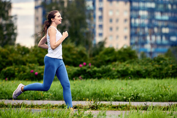 Running in rainy weather in summer by woman 29 years old in leggins.