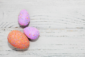 Multi-colored Easter decorative eggs on a pastel background.