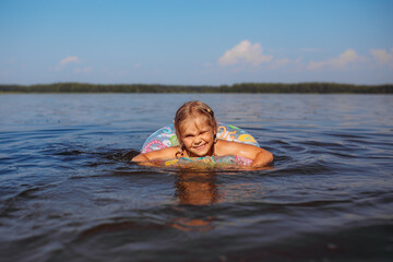 baby girl bathing in water, lake, splashes, summer, heat, children's smile, happiness